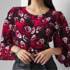 COPY - A feminine rose print blouse with ruching, ruffled sleeves, and a scallo…
